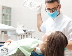 A woman having her teeth checked for gum disease by a dental professional