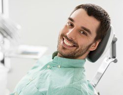 Smiling man in the dental chair before root canal therapy