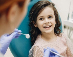 A young girl smiling in the dentist’s chair