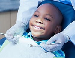 A young boy having his teeth checked by a children’s dentist