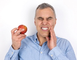 Man with tooth pain due to failed dental implant in Thorndale