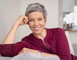 Confident, smiling woman after full mouth reconstruction