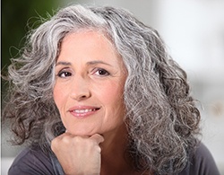 Woman smiles thinking about the benefits of dental implants in Thorndale