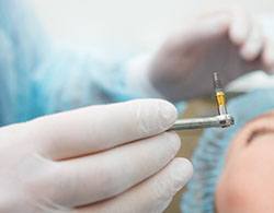 Dentist placing dental implants