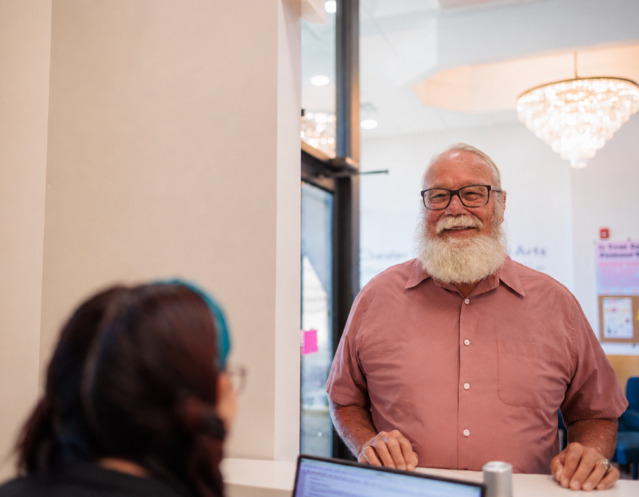 Dr. Simeone greeting an implant patient at the front desk