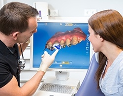 Dentist and patient looking at Invisalign treatment planning software