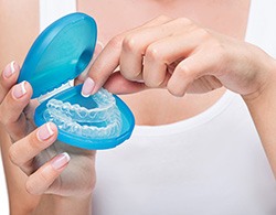 Person inserting trays into a protective case