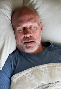 Man in sleeping soundly thanks to sleep apnea therapy