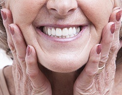 Woman showing off smile after full mouth reconstruction