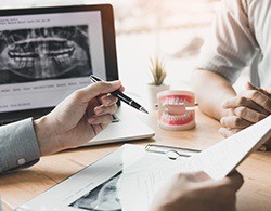 Dentist and patient reviewing dental insurance forms