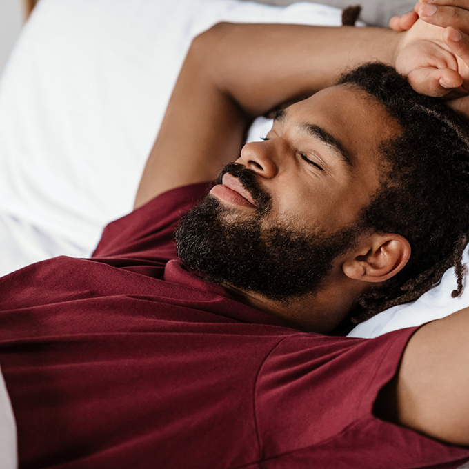 Bearded man lying in bed