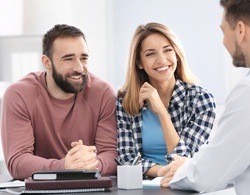 A couple talking with the dentist about nightguards for T M J