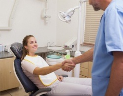 Patient shaking dentist’s hand during oral cancer screening visit