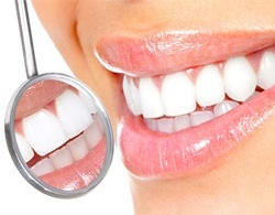 Dental mirror and teeth during oral cancer screening