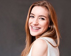 Smiling woman with traditional braces