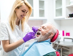 A man having his mouth checked by the dentist during periodontal therapy visit