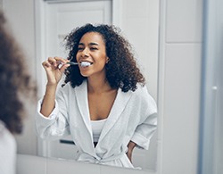 Woman brushing teeth in Thorndale