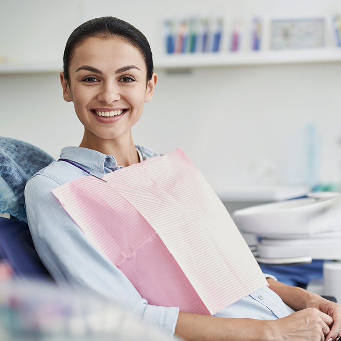 Smiling patient sitting in dental chair