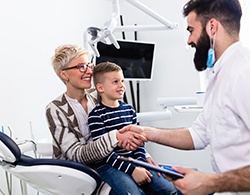 Mom and son greeting dentist during sealant appointment