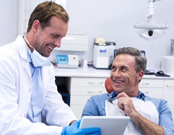 Happy male patient and dentist discussing sedation dentistry options