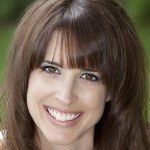 Woman with brown hair smiling after cosmetic dentistry