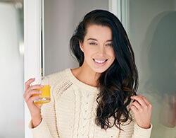 Woman smiling after cosmetic dentistry treatment with tooth colored fillings