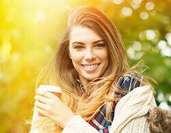 woman holding cup of coffee