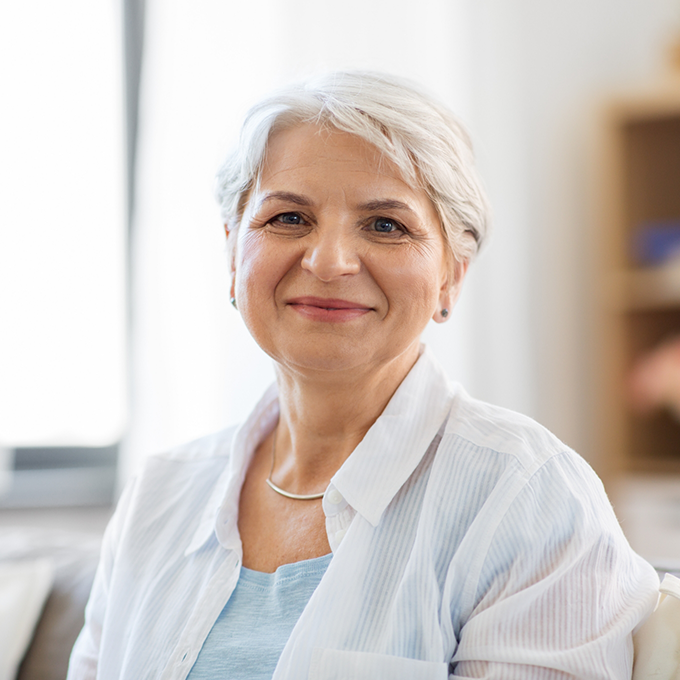 Smiling senior woman in white shirt