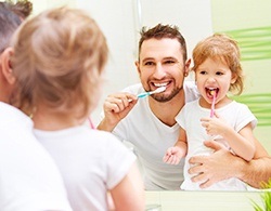 family brushing teeth