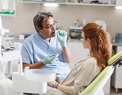 A dentist talking to a female patient about tooth colored fillings