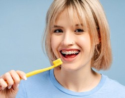 Woman with braces, holding toothbrush