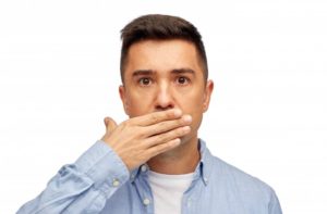 A man hiding his teeth.