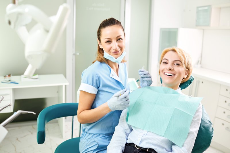 a woman and her dentist smiling in preparation for a standard dental checkup and cleaning