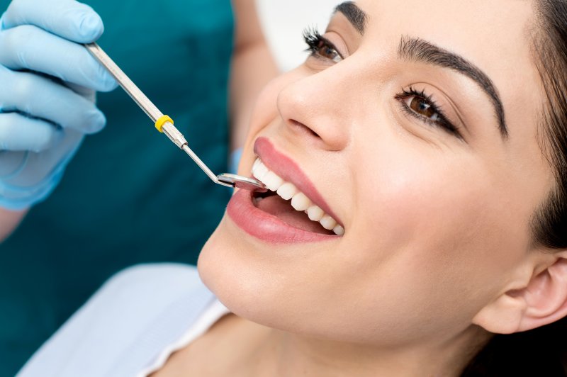 a woman receiving a dental checkup in Coatesville