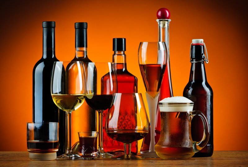 A wide variety of alcohol lined up on a table