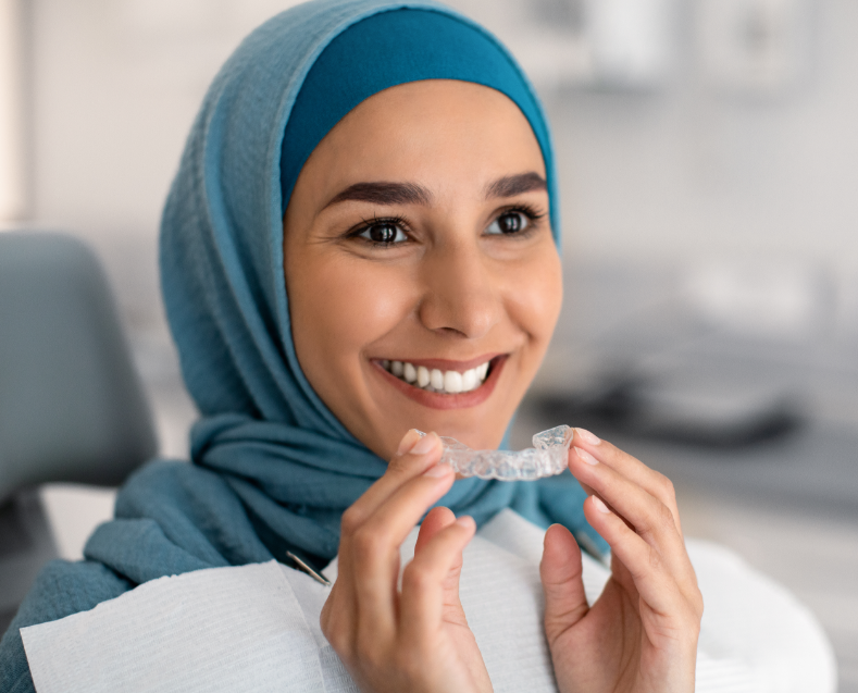 Woman holding clear aligner